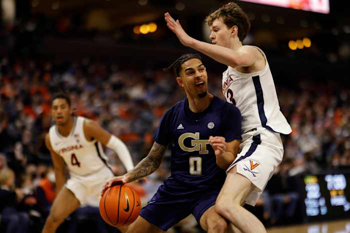 Georgia Tech Yellow Jackets guard Michael Devoe dribbles against Virginia Cavaliers guard Kody Stattmann.